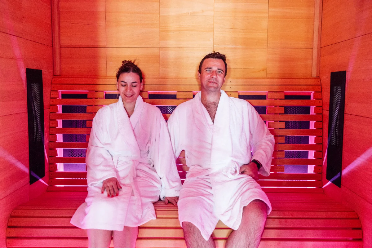 Couple in white robes relaxing in infrared sauna 2026 03 17 04 10 09 utc